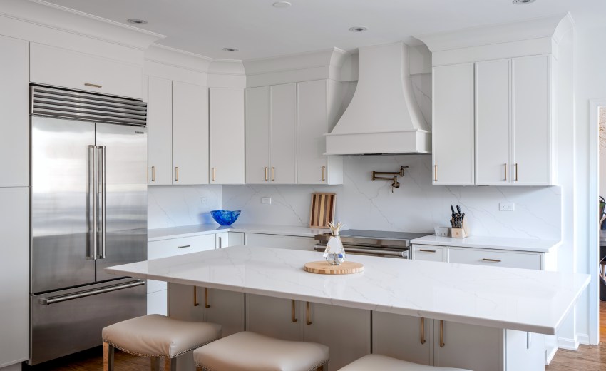 a modern kitchen with white cabinets and a large island