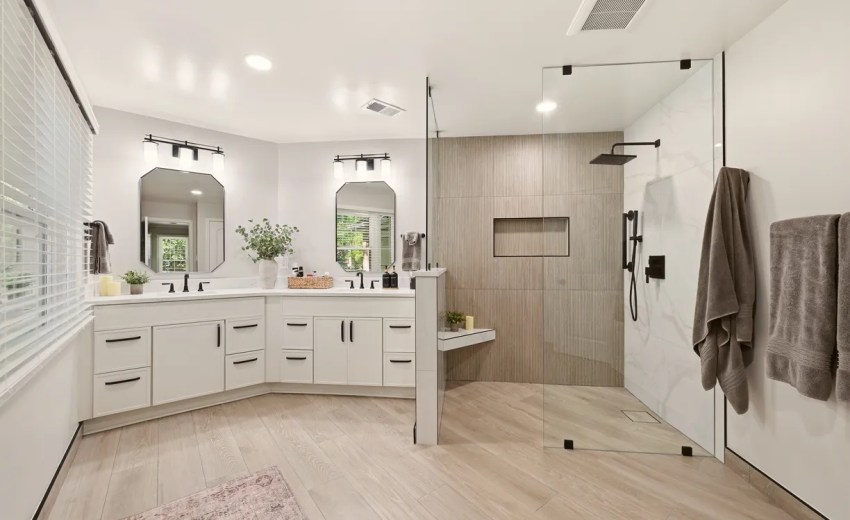 Master bathroom remodel in Vienna VA with white double vanity, matte black fixtures and wood look tile bathroom floor